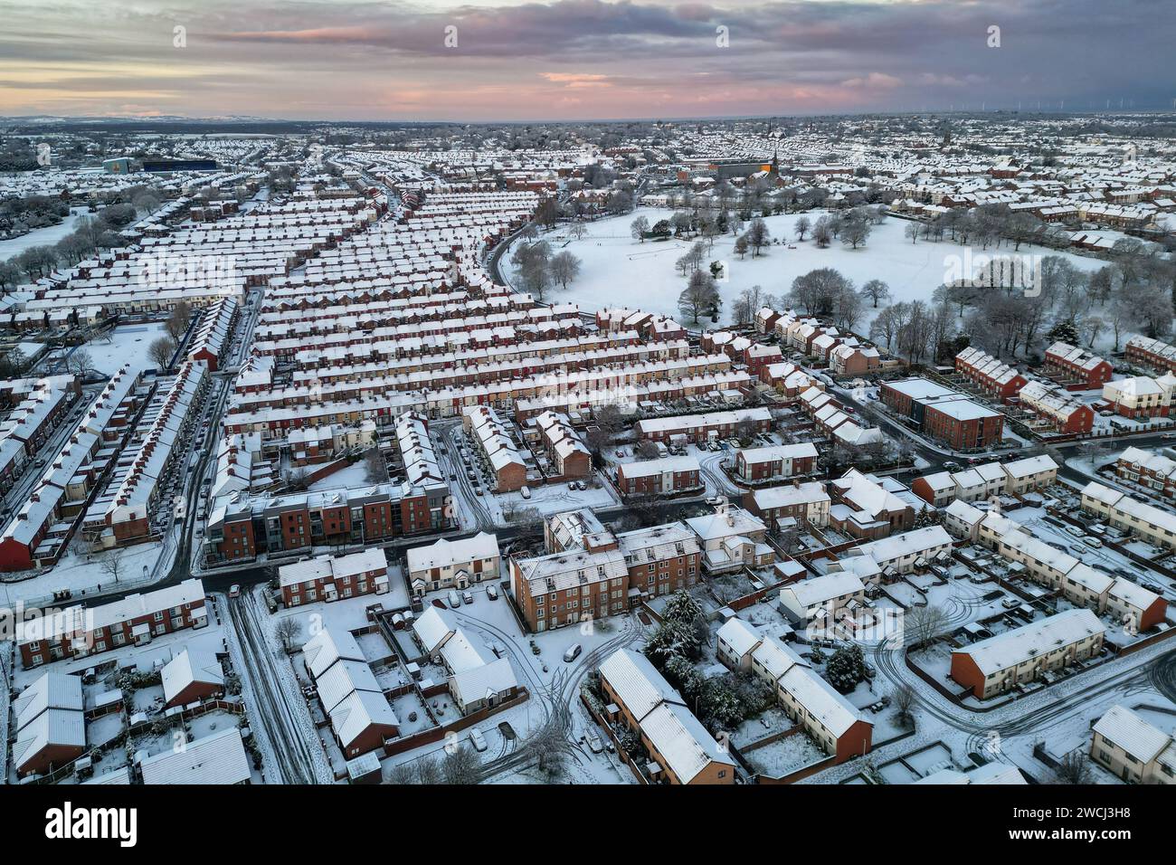 Birkenhead, UK. 16th Jan, 2024. An aerial view of snow covering houses