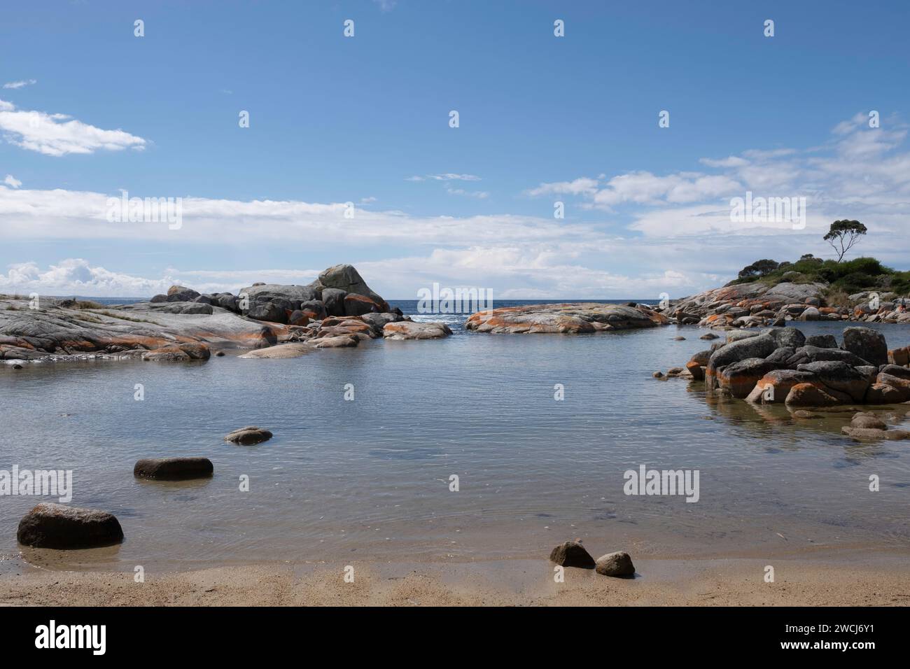 Orange-hued granite rocks in the Bay of Fires on the northeastern coast ...