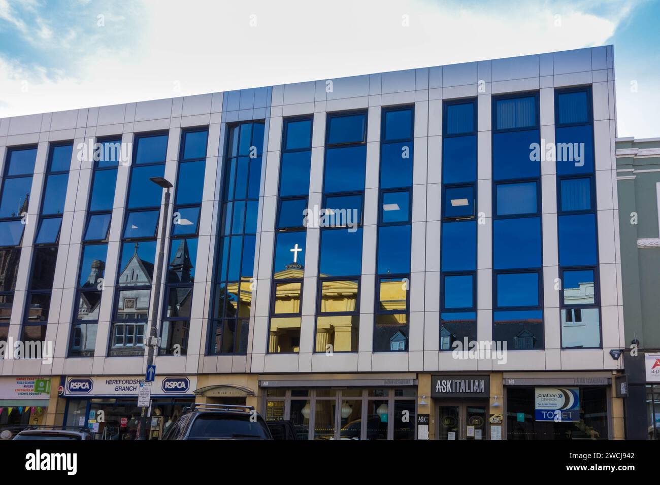 Reflection in windows of St Francis Xavier Church and the old post
