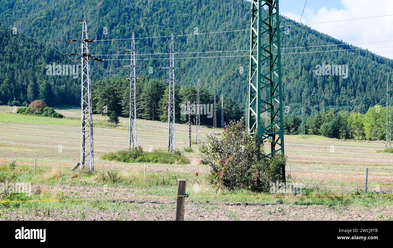 Large power poles with power lines with forest background Stock Photo ...
