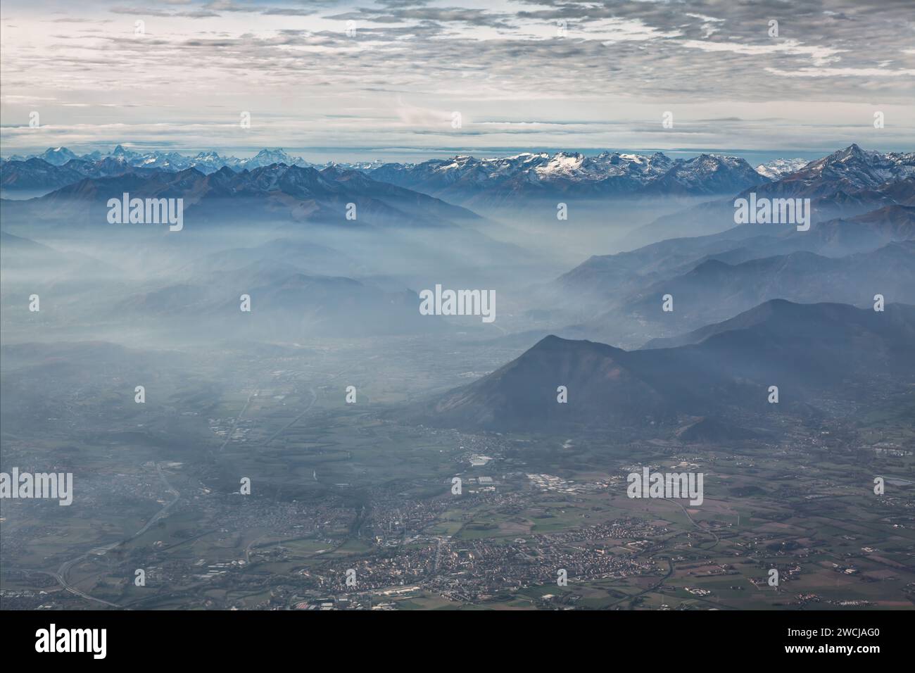 Aerial view of the snow capped mountains in the clouds Stock Photo - Alamy