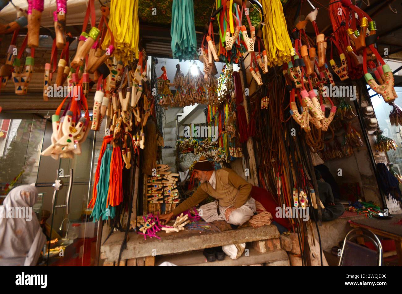 Peshawar, Peshawar, Pakistan. 16th Jan, 2024. Slingshot on sale at market in Peshawar.A Pakistani man makes handmade slingshots at a shop in Peshawar, Pakistan, 16 january 2024. A slingshot is a small hand-powered projectile weapon the classic form consists of a Y-shaped frame held in the non-dominant hand, with two natural-rubber strips, rubber tubes or rubber bands attached to the upper two ends. (Credit Image: © Hussain Ali/ZUMA Press Wire) EDITORIAL USAGE ONLY! Not for Commercial USAGE! Stock Photo
