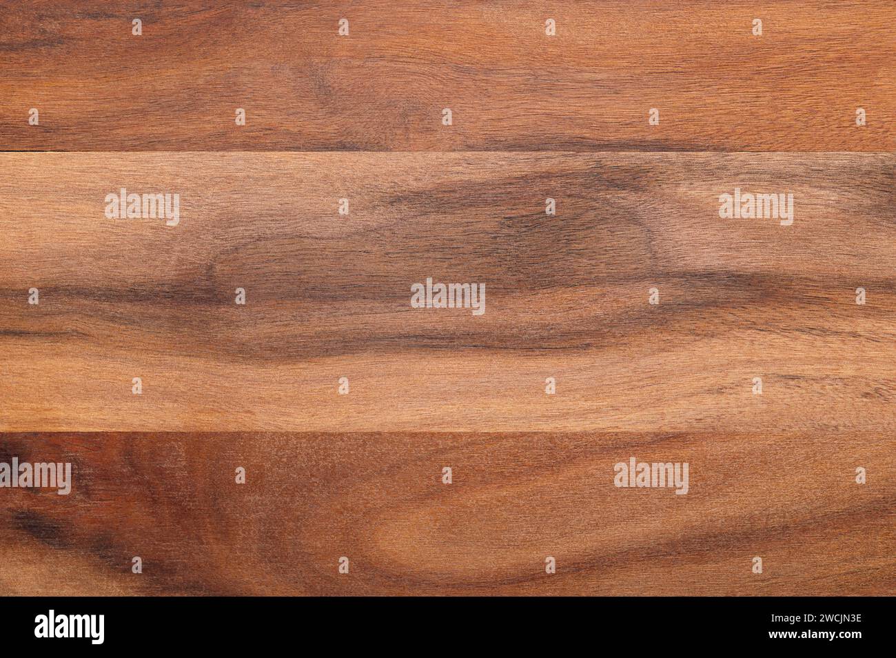 Surface of an olive wood board. Glued together dried boards of olive wood, cut parallel to its longitudinal axis. Very hard and tough material. Stock Photo