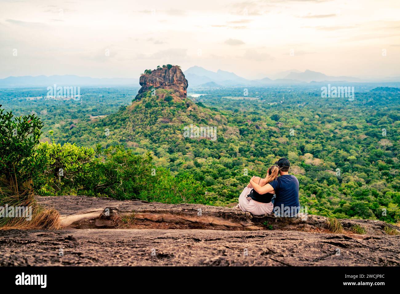 Couple in Sigiriya, rock view. Woman and man, summer travel. People on vacation in Sri Lanka. Beautiful nature with green landscape and mountains. Stock Photo