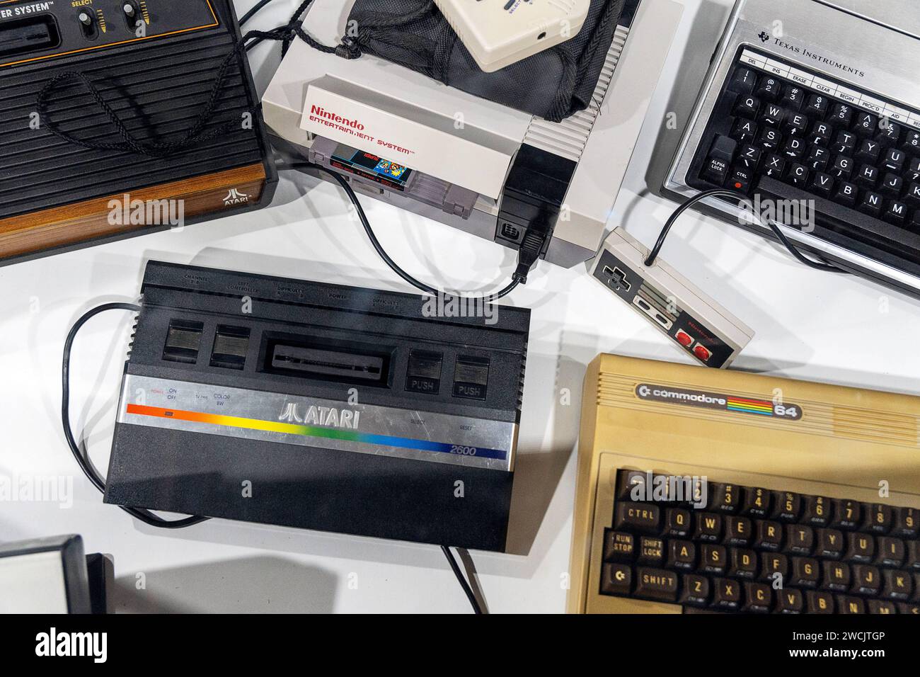 Malta - December 3, 2023: Nostalgic game consoles on a table. Atari, Comandore and Nintendo *** Nostalgische Spieleconsolen auf einem Tisch. Atari, Comandore und Nintendo Stock Photo