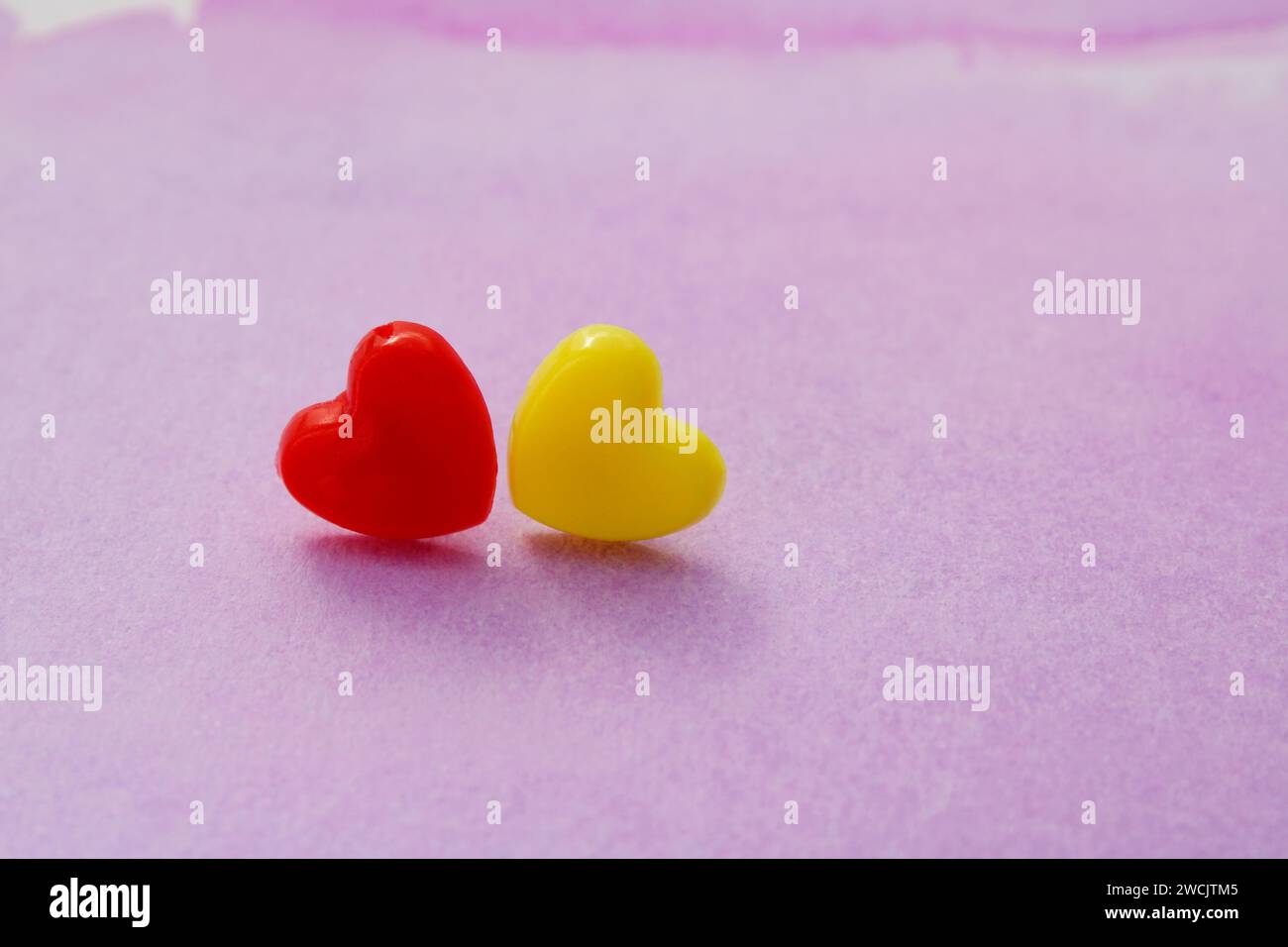 Couple of red and yellow hearts in love Stock Photo