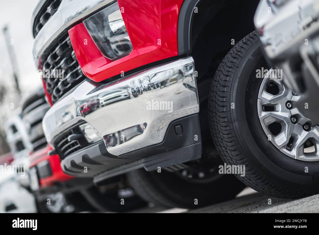 New and Pre Owned Pickup Trucks Dealership Inventory Automotive Theme. Stock Photo