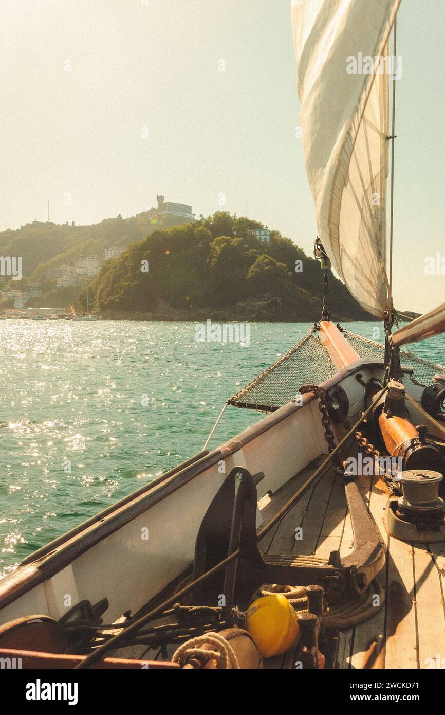 A man sailing on a boat in the serene waters Stock Photo