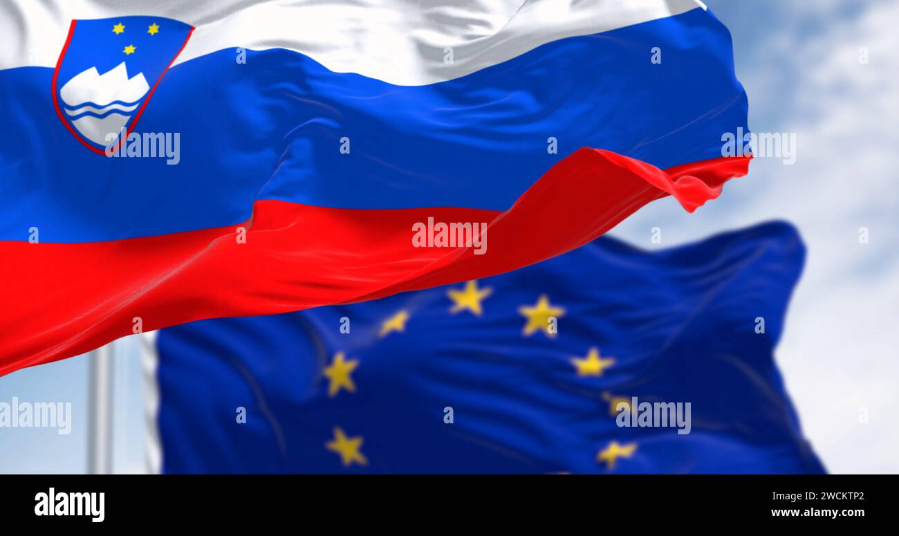 The flags of Slovenia and the European Union fluttering together on a clear day. Slovenia has been a member of the eurozone since January 1, 2007. 3D Stock Photo