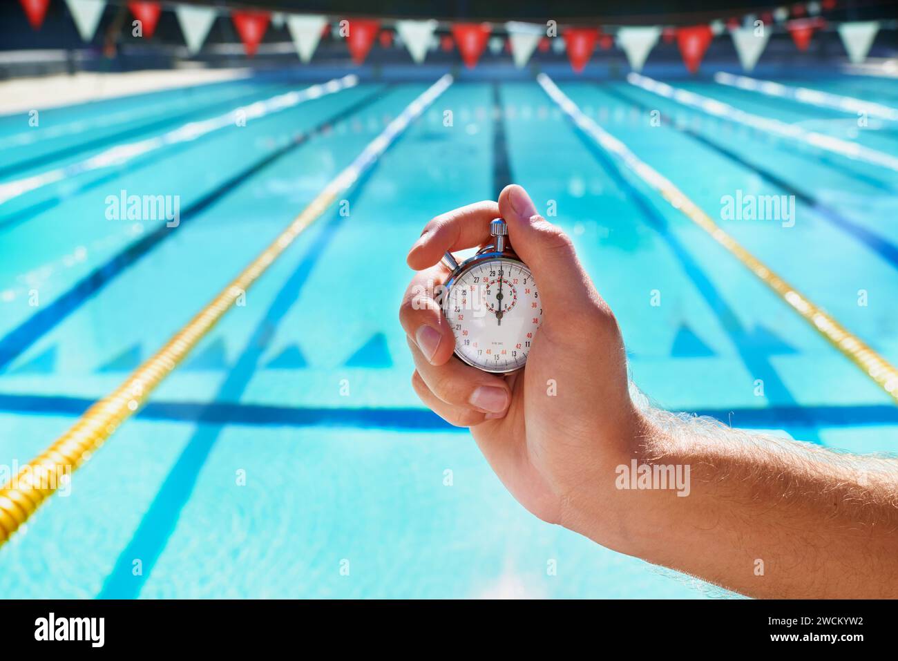 Hand, stopwatch and swimming pool for sport, training and workout with
