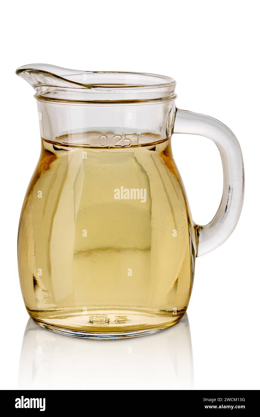 White wine in 0.25-liter glass carafe with sign indicating quantity - Jug of white wine isolated on white with clipping path included Stock Photo