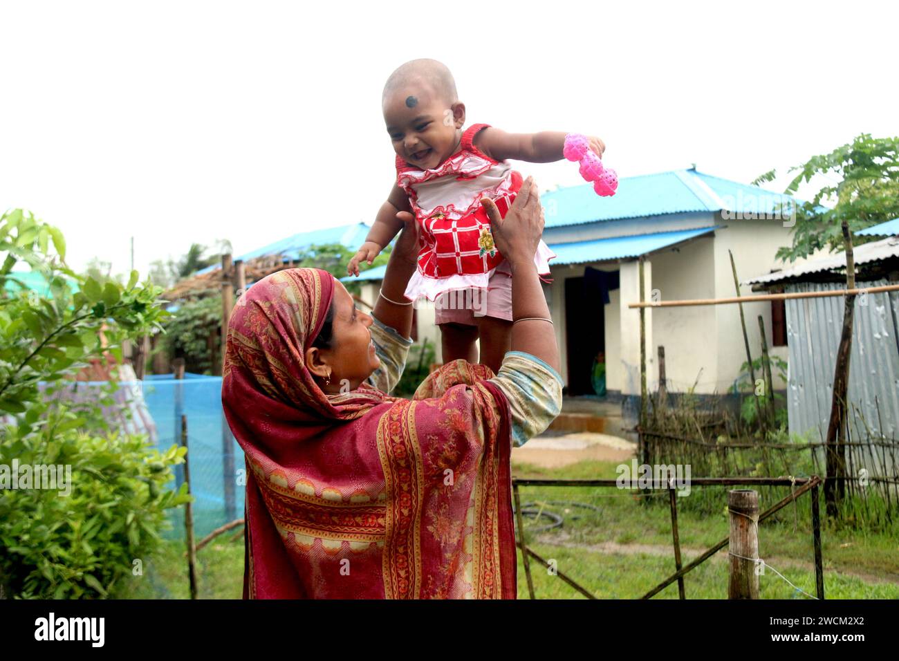 Mother's Love. A Bangladeshi mother carrying her child with love ...