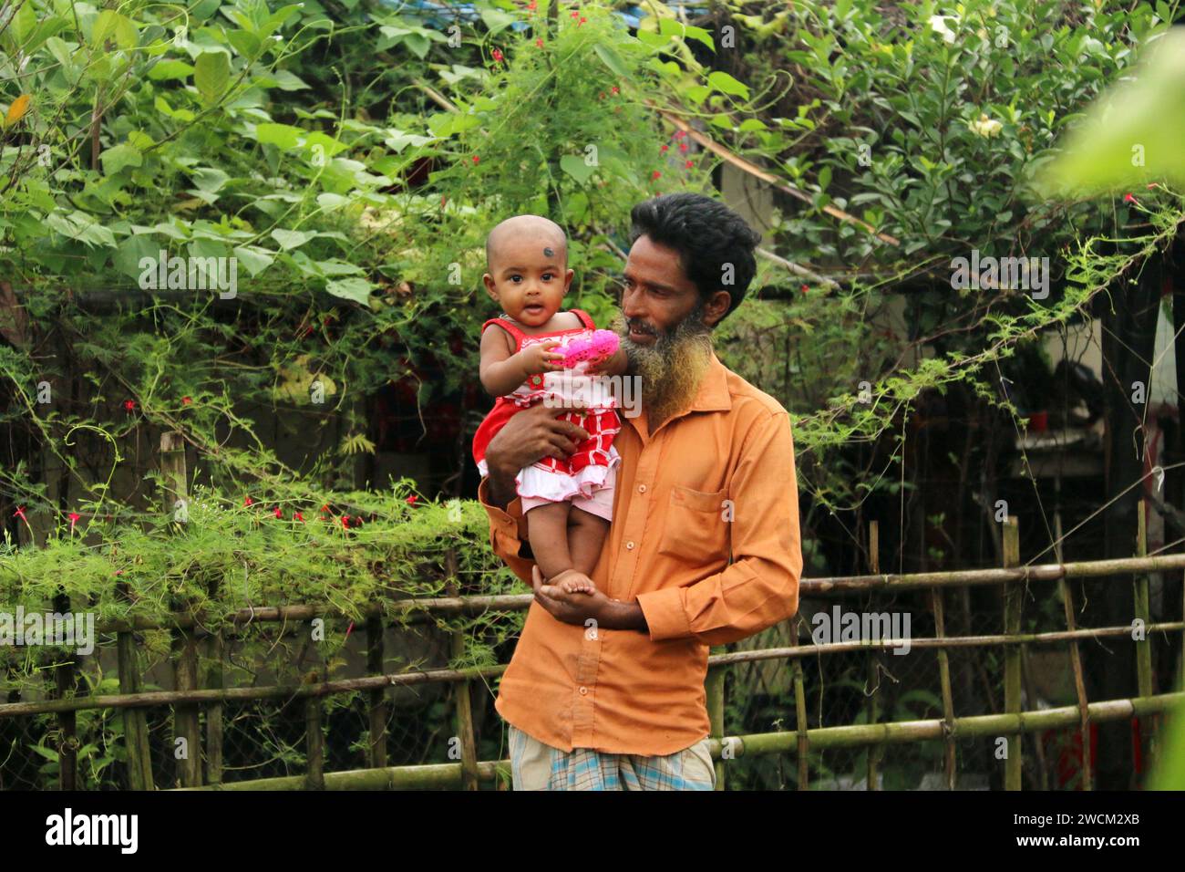 Fathers Love. A Bangladeshi father carrying his child with love