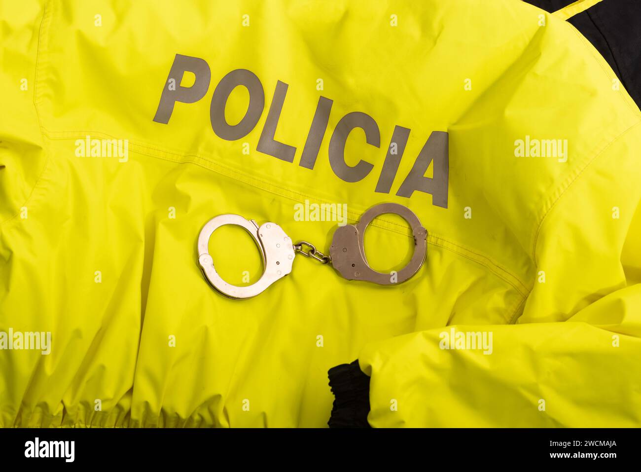 Yellow police uniform with handcuffs. Enforcement and public safety Stock Photo