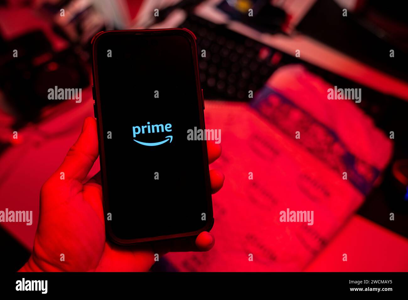 Man holding an Apple iPhone 14 Pro Max smartphone with Amazon Prime