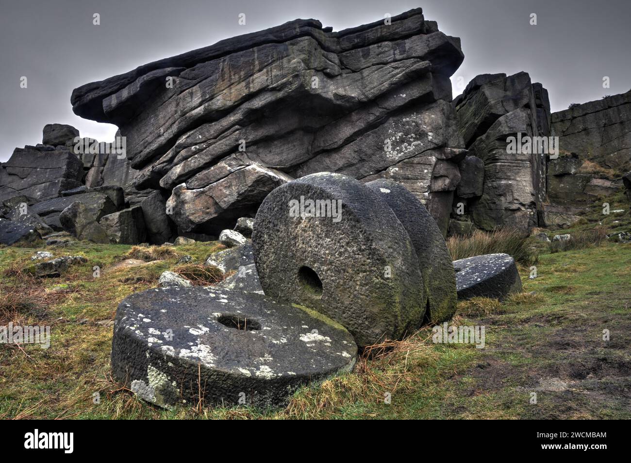Abandoned Millstones at Stanage Edge, Derbyshire, a great place to climb or walk amongst eroded gritstone boulders. Stock Photo