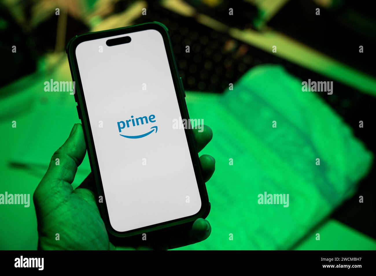 Man holding an Apple iPhone 14 Pro Max smartphone with Amazon Prime