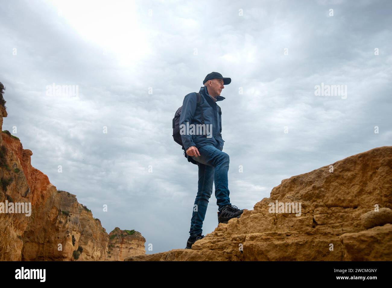 Man walking over rocks hi-res stock photography and images - Alamy