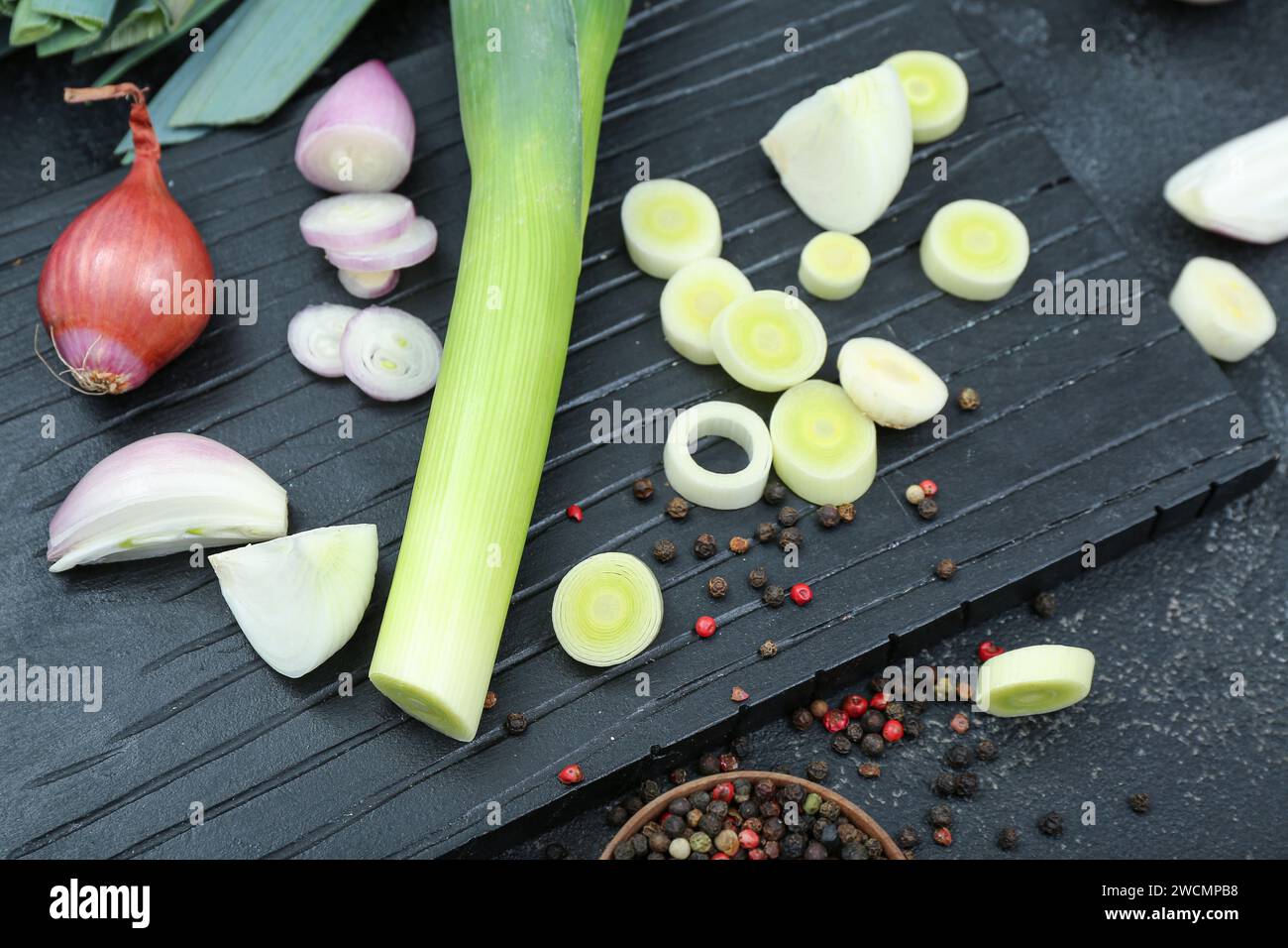 Board with different kinds of onion on grunge black background Stock ...