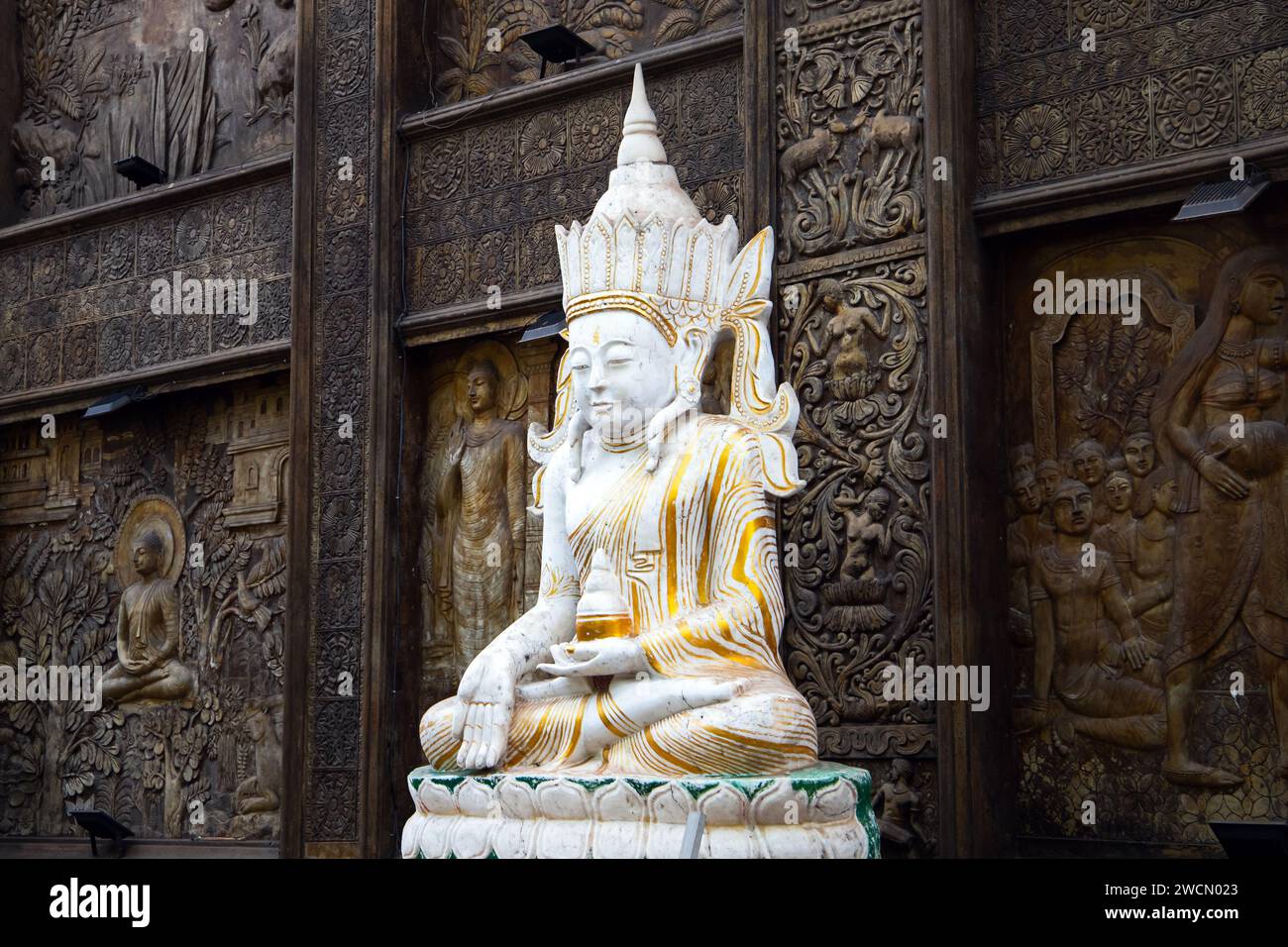 White Buddha statue at Gangaramaya Temple, it is one of the most important temples in Colombo, Sri Lanka Stock Photo