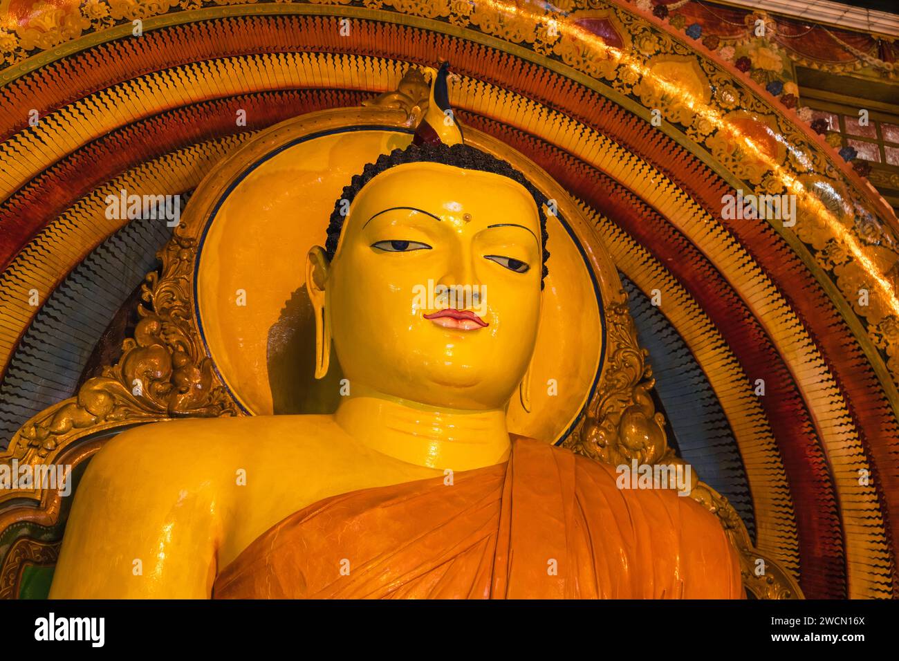 Face of the Buddha statue of the Gangaramaya temple, one of the biggest Buddhist temples of Colombo, the capital city of Sri Lanka Stock Photo