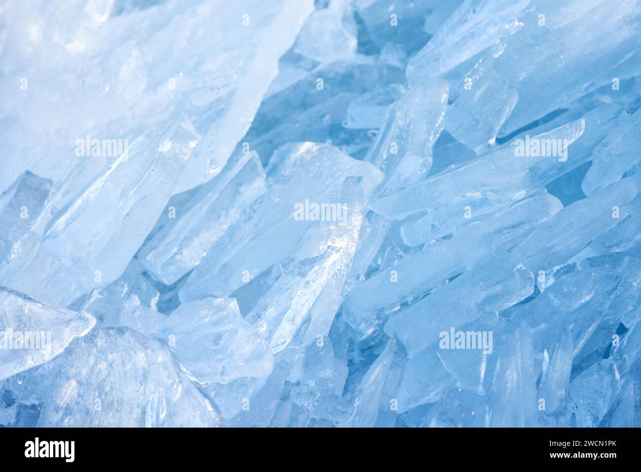 Ice shards lay at the coast of frozen Baltic Sea on a sunny winter day, close-up photo with selective focus Stock Photo