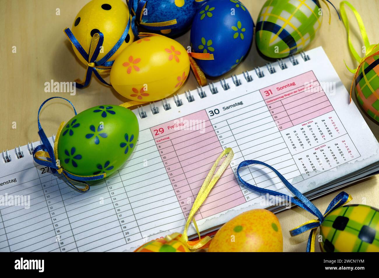 Symbolic image of the Easter holidays Easter eggs around a calendar