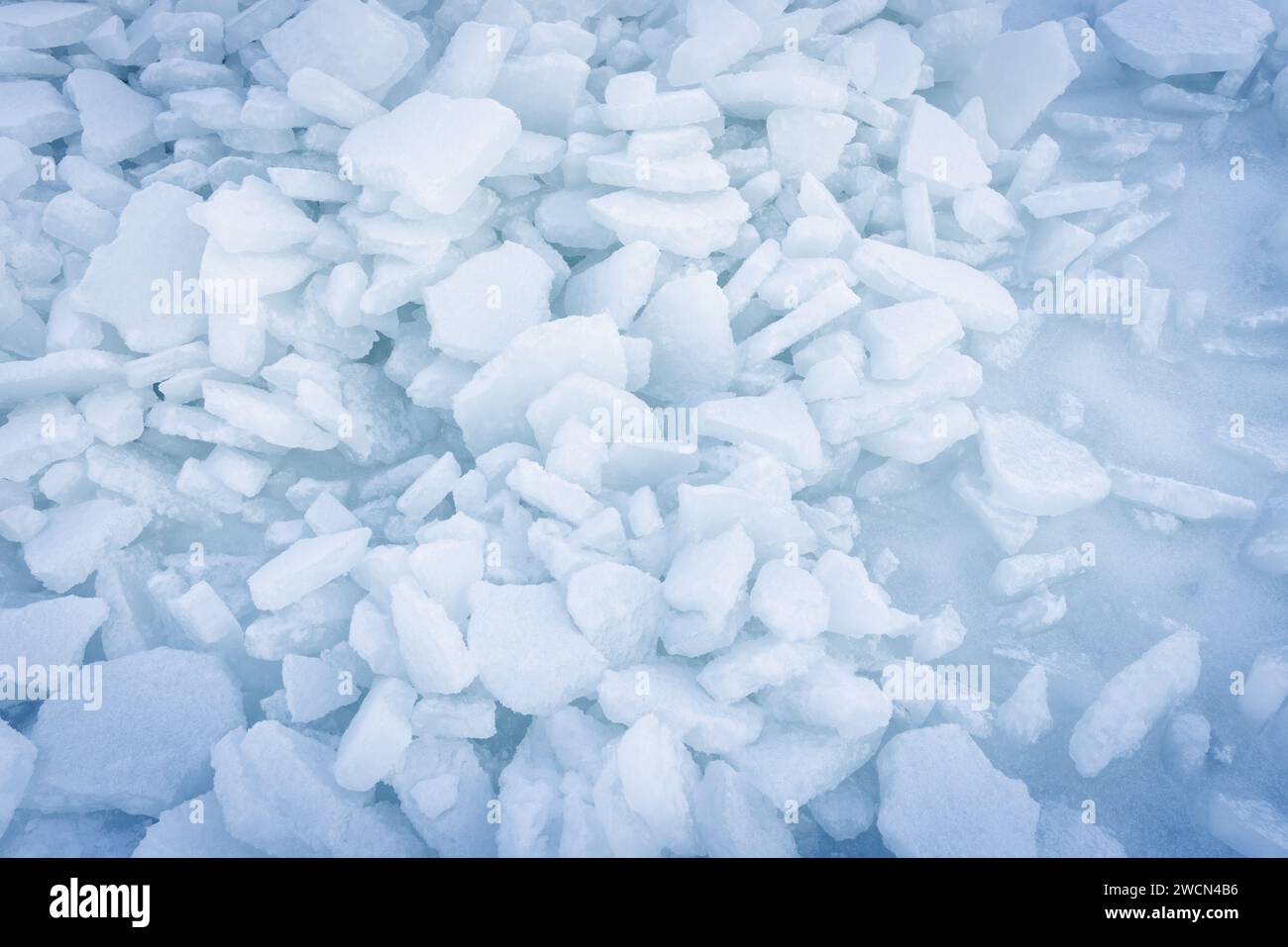 Ice hummocks background texture. Broken ice shards lay on frozen Baltic Sea surface on a winter day, top view Stock Photo