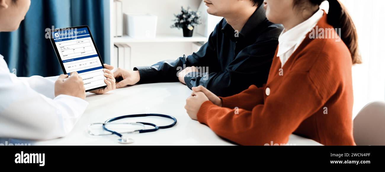 Couple attend fertility consultation with gynecologist at hospital as part family planning care