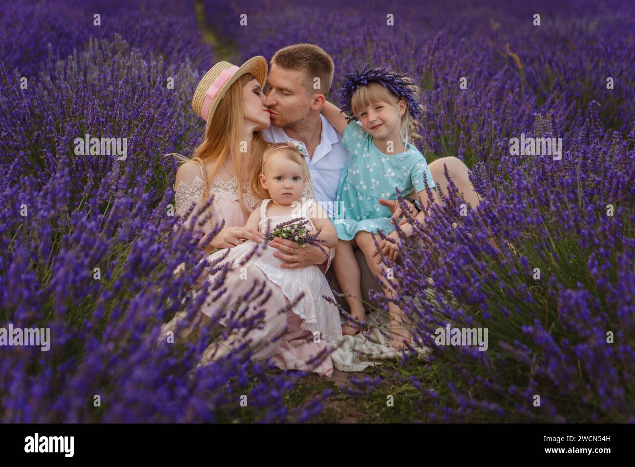 Happy family, father and mother with two daughters on a picnic at lavender field Stock Photo