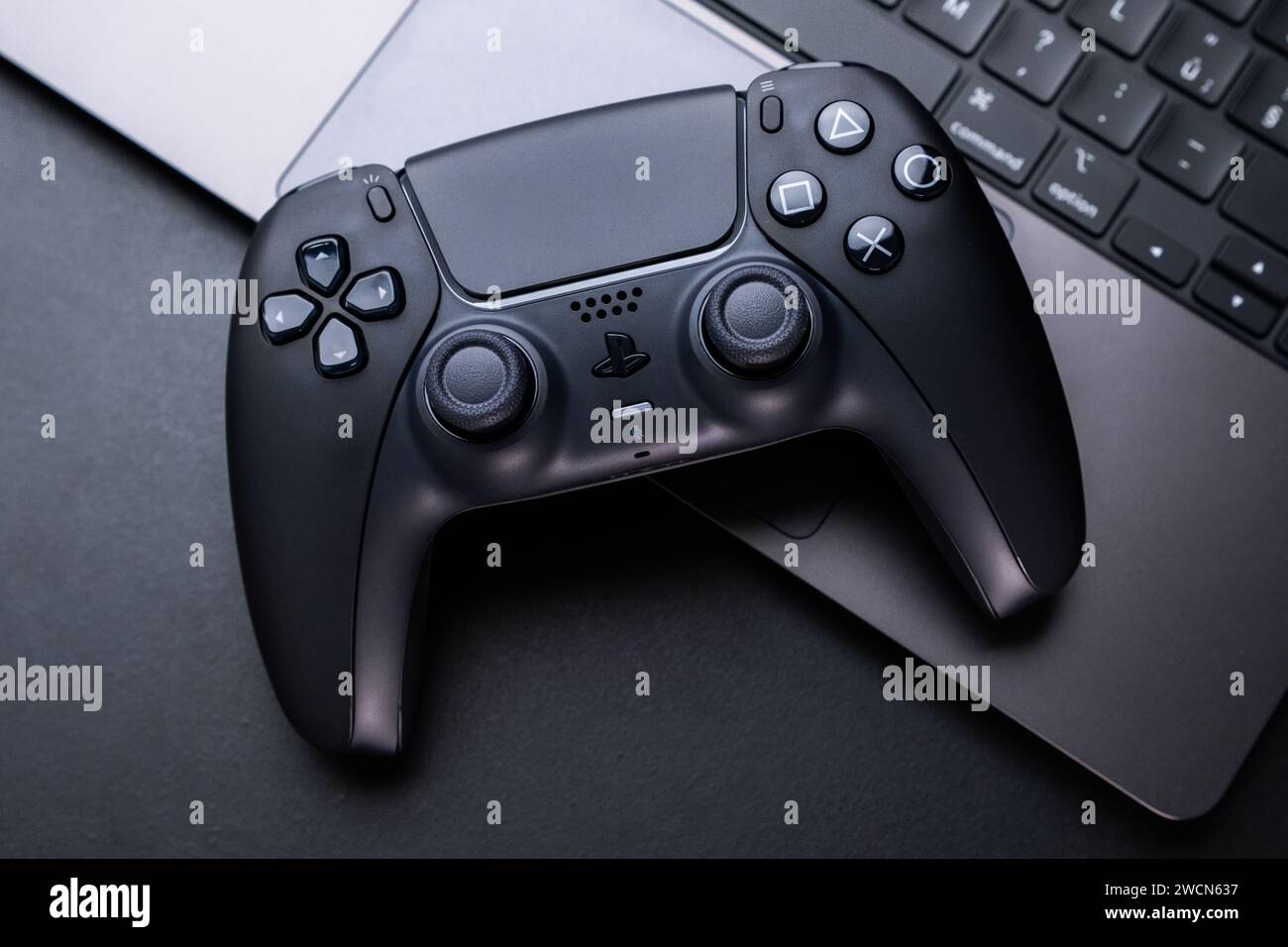BERLIN , GERMANY JANUARY 14 2024 Detailed view of a DualSense controller positioned beside a