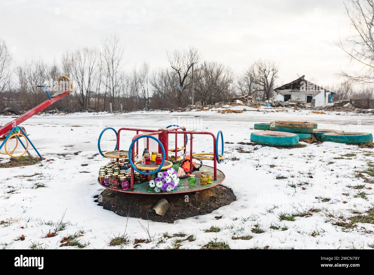 Memorial flowers for victims who were killed during the missile strikes are seen on a children's carousel on the playground near the site of the tragedy. Missile strikes on the village of Groza, Kupyansk district, Kharkiv region, which was carried out on 5 October 2023, and it was one of the bloodiest attacks during invasion. A shop and a cafe were attacked, and the attack occurred when locals had gathered for a memorial service at the cafe. Fifty-nine people were killed and five were wounded. (Photo by Mykhaylo Palinchak/SOPA Images/Sipa USA) Stock Photo