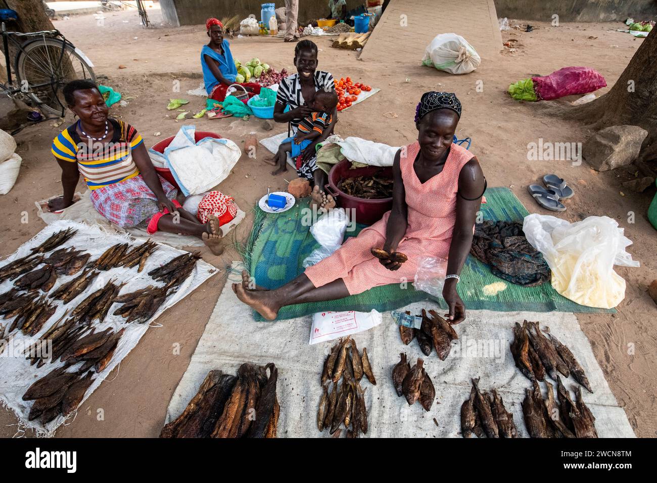 Uganda, Adjumani. Women sell dried fish in the market. Editorial use only. Stock Photo