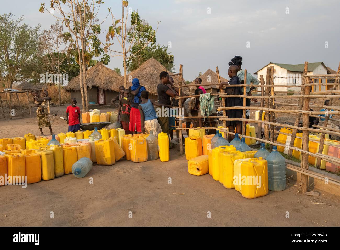 Uganda, Adjumani. South Sudan refugees in refugee camps line up to fill their water jugs. Editorial use only. Stock Photo