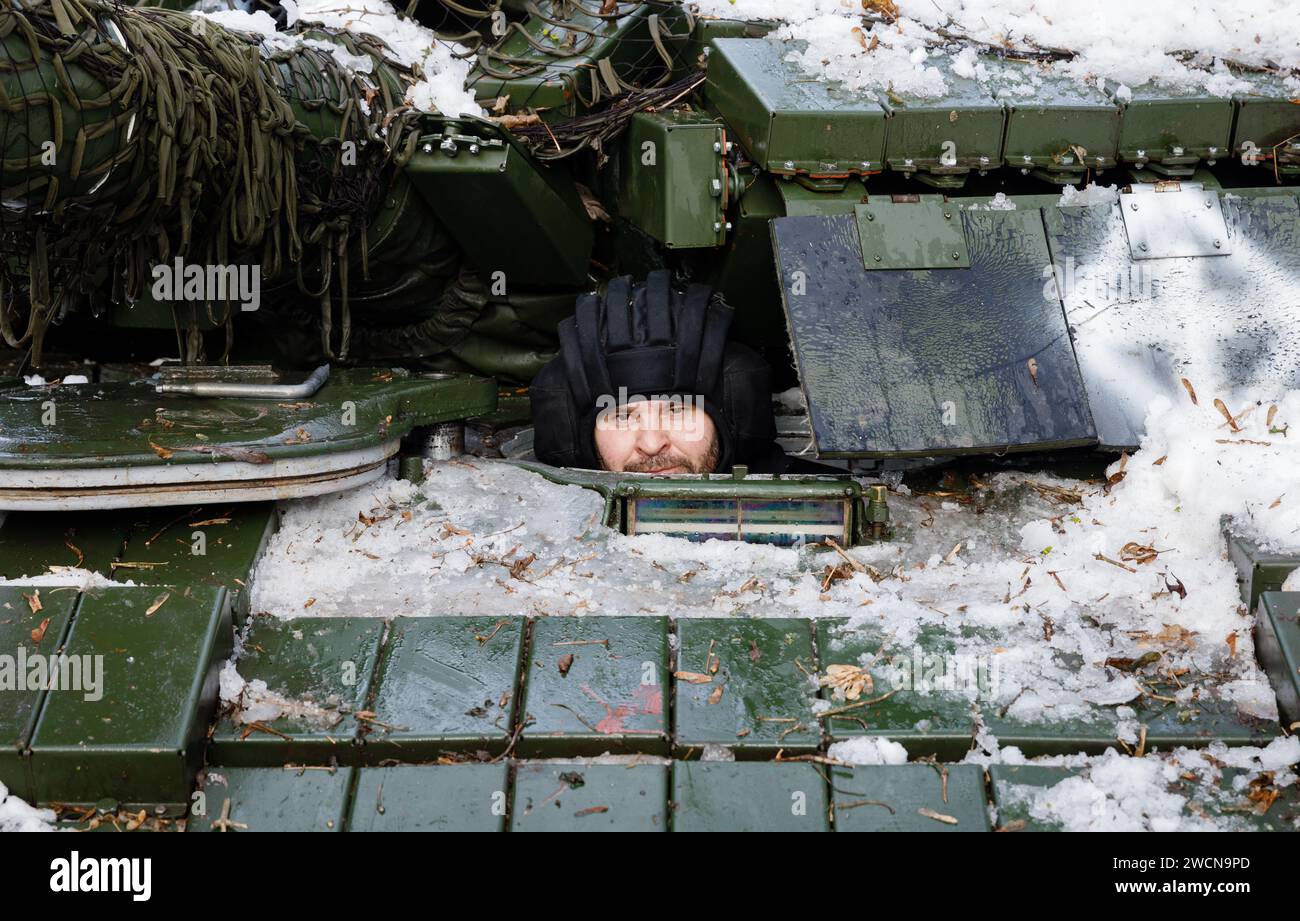 A tank crewman is seen in the hatch of the tank. Tank battalion of the 41st Mechanized Brigade of the Armed Forces of Ukraine in Kharkiv region, Ukraine. The war of the Russian Federation against Ukraine has been going on for 2 years now. Ukrainian troops are courageously defending their country. Stock Photo