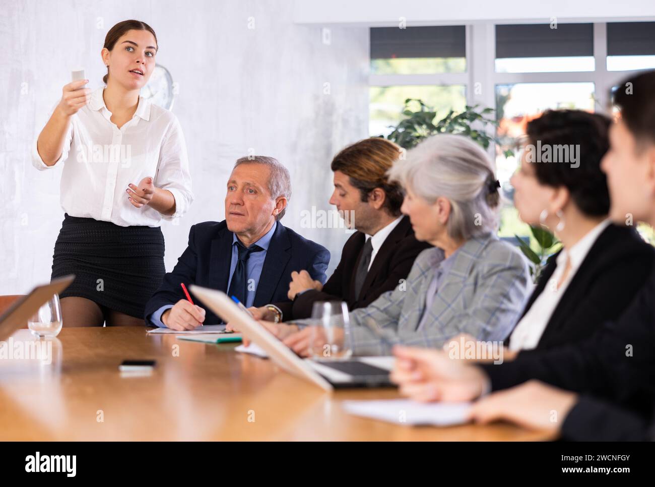 Young business woman making slideshow presentation for partners in office Stock Photo