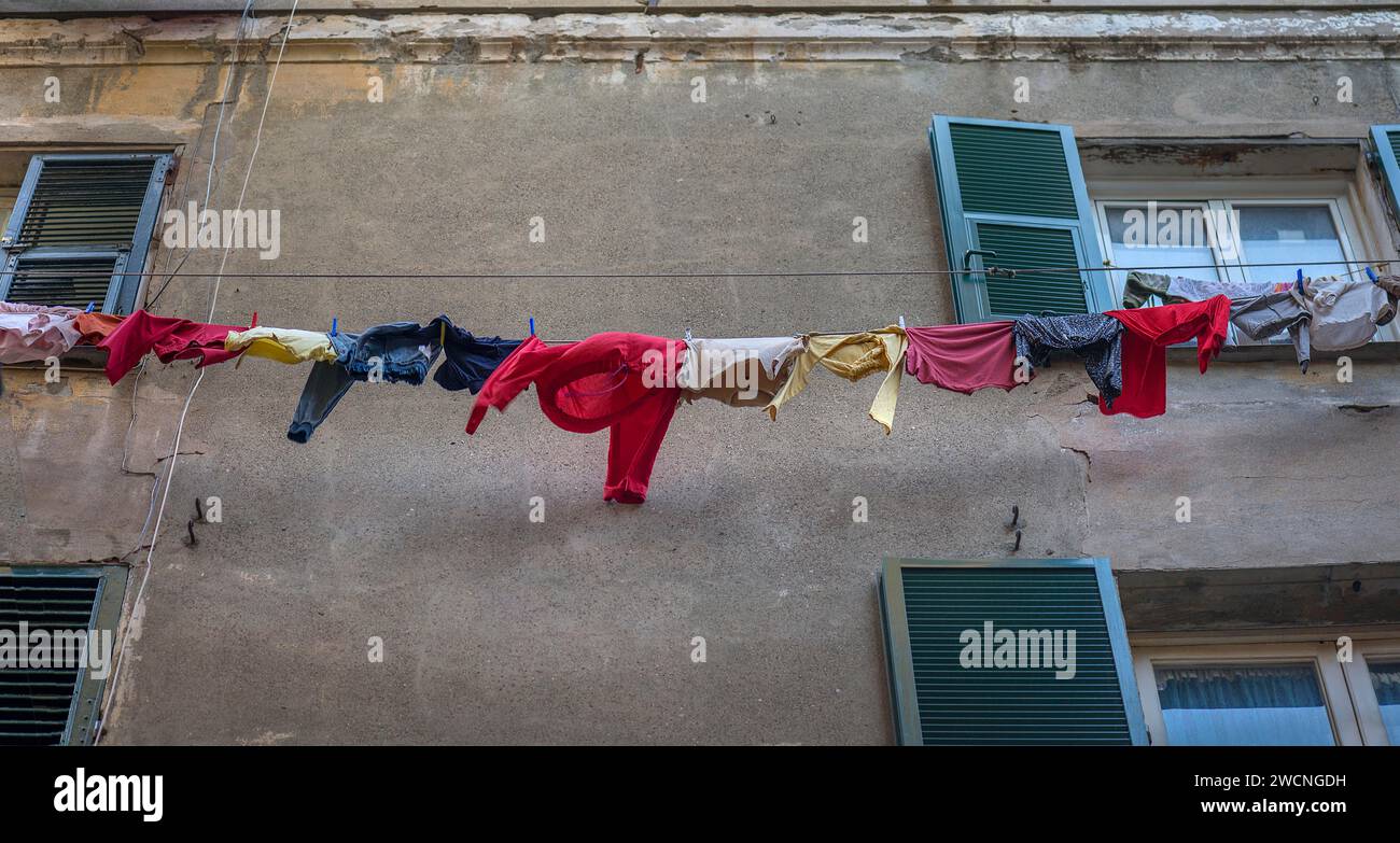 Colourful laundry on the line at a residential building in the old town, Genoa, Italy Stock Photo