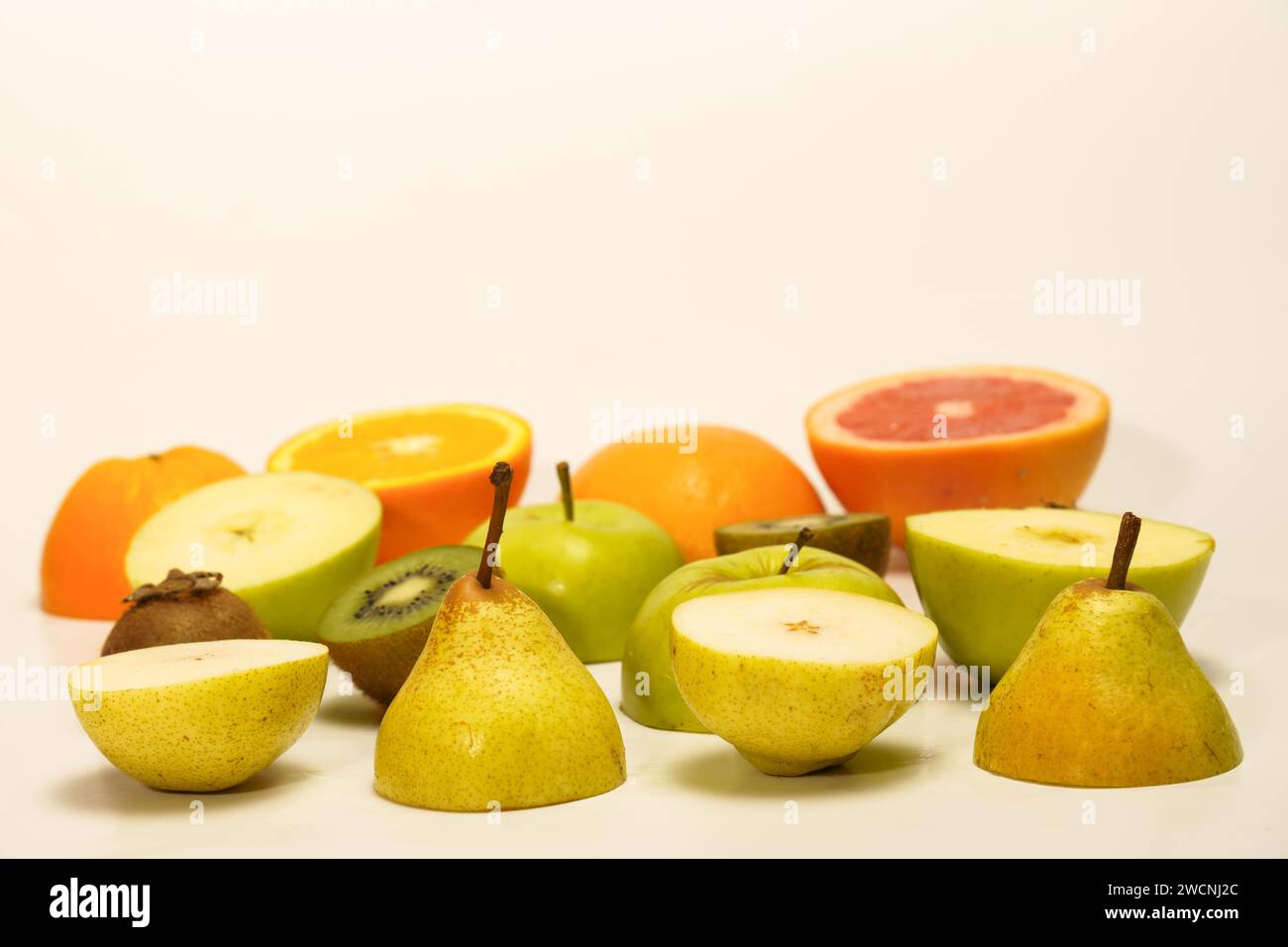 Fresh fruit cut in half isolated on a white background.pear, kiwi