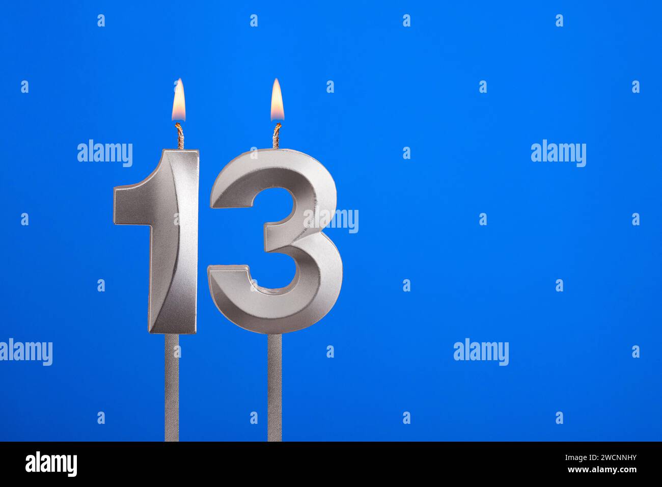 birthday-candle-number-13-celebration-card-on-blue-background-stock