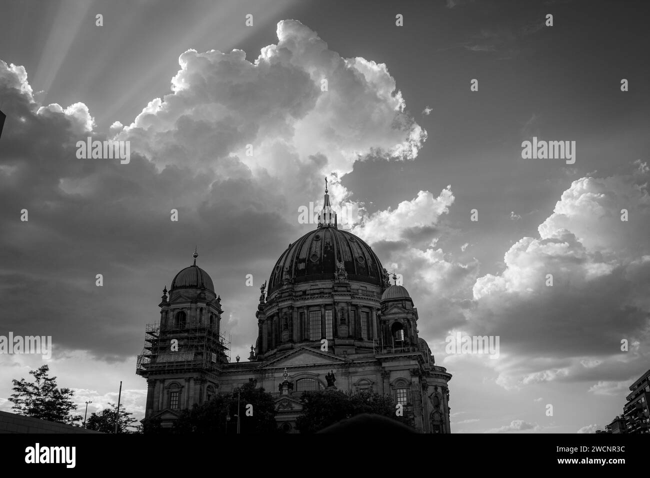 Berlin cathedral with clouds and sunrays in black and white Stock Photo