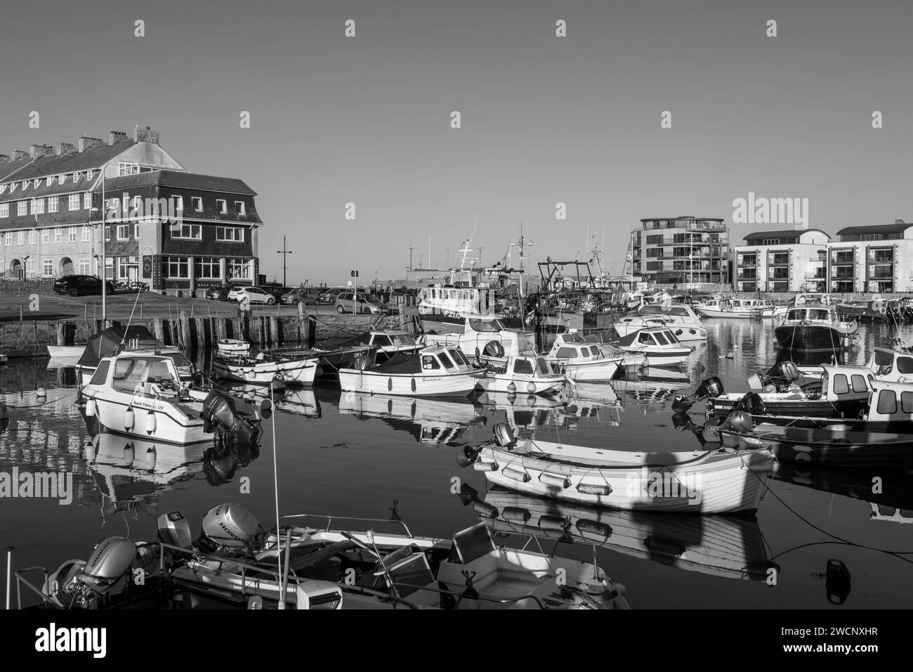 Fishing boats moored in West Bay harbour in Dorset Stock Photo - Alamy