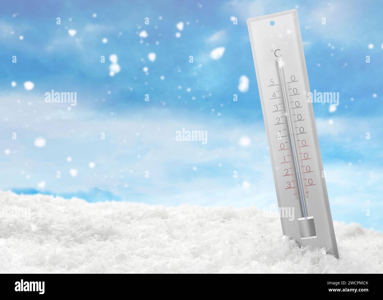 Thermometer in snow showing temperature below zero outdoors on winter day Stock Photo