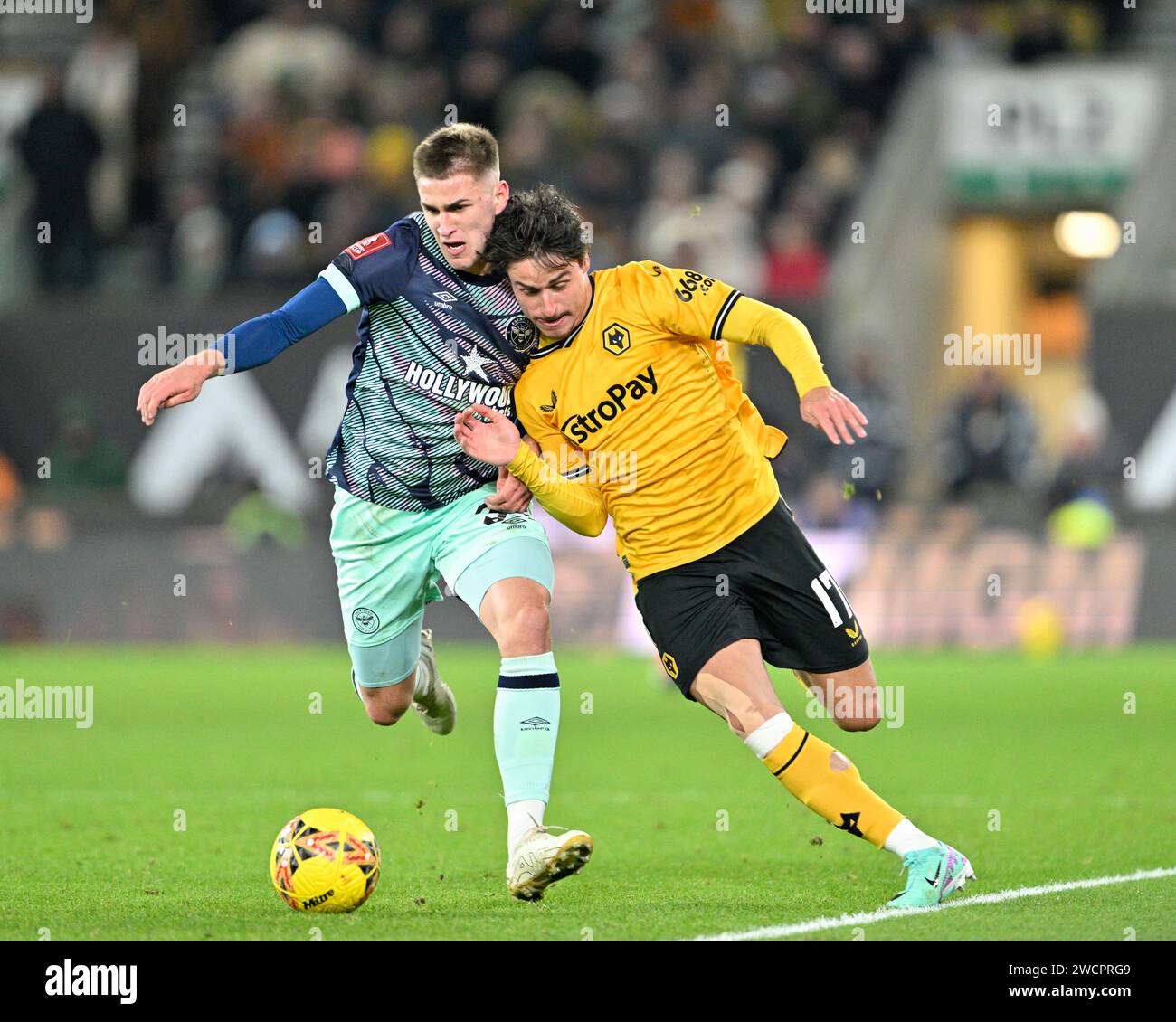 Wolverhampton, UK. 16th Jan, 2024. Hugo Bueno of Wolverhampton Wanderers and Yehor Yarmolyuk of Brentford battle for the ball, during the Emirates FA Cup Third Round Replay match Wolverhampton Wanderers vs Brentford at Molineux, Wolverhampton, United Kingdom, 16th January 2024 (Photo by Cody Froggatt/News Images) in Wolverhampton, United Kingdom on 1/16/2024. (Photo by Cody Froggatt/News Images/Sipa USA) Credit: Sipa USA/Alamy Live News Stock Photo
