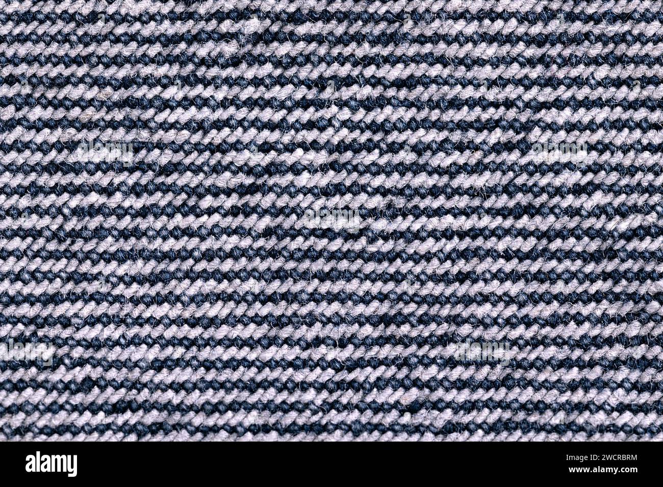 Backside of denim surface, blue jeans fabric, from above. Sturdy cotton warp-faced fabric. Type of textile. Stock Photo