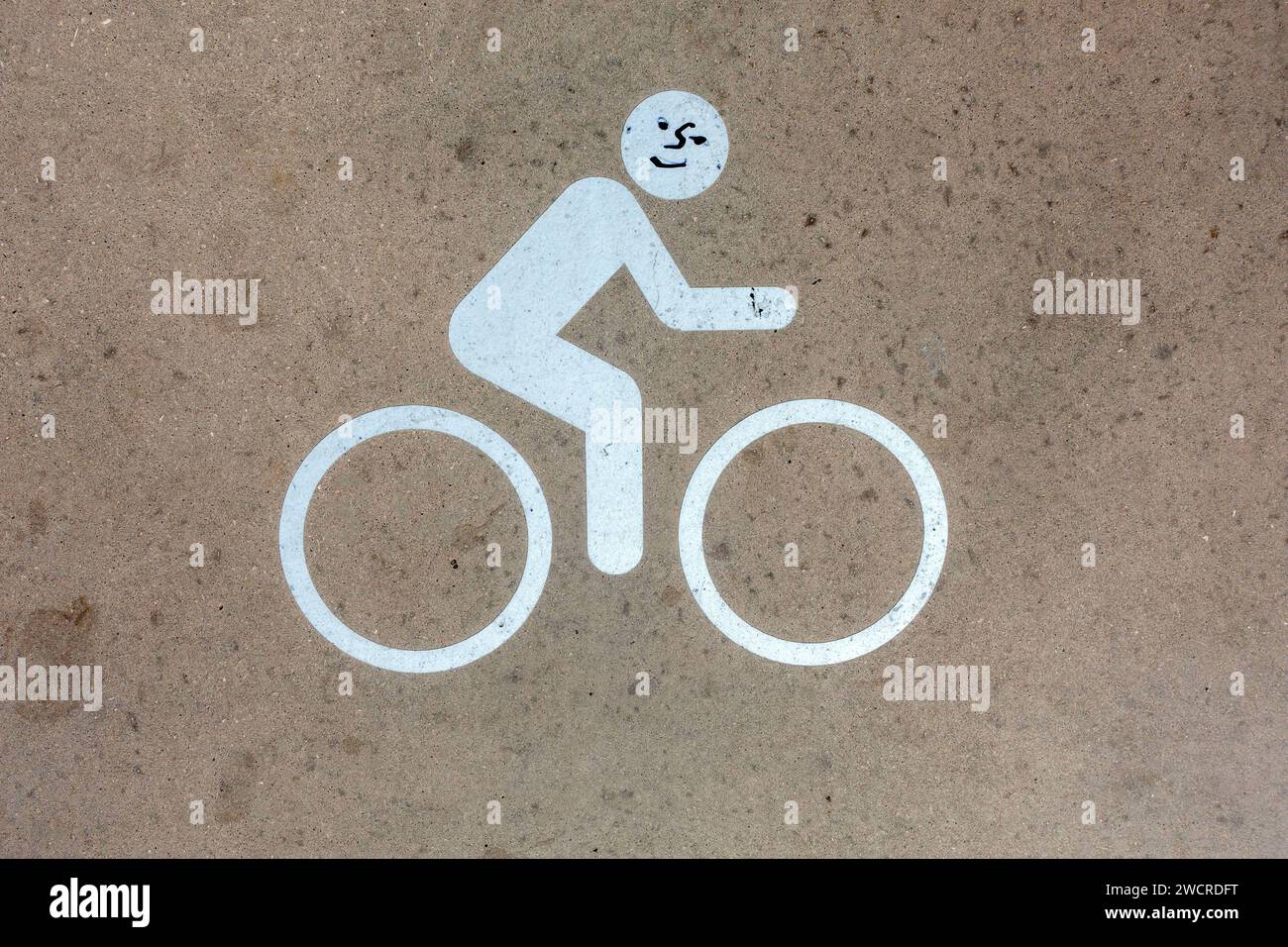 Cycle Lane Sidewalk Street Sign On The Pavement With Graffiti Face Added  In Tavira December 30, 2023 Stock Photo