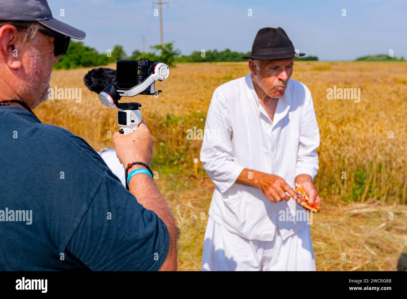 Professional videographer filming interview hi-res stock photography ...
