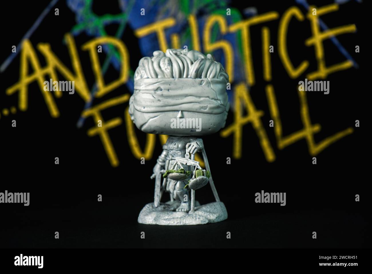 Funko POP vinyl figures of Lady Justice statue of And Justice for All of american heavy metal group Metallica in front of Metallica poster. Illustrati Stock Photo