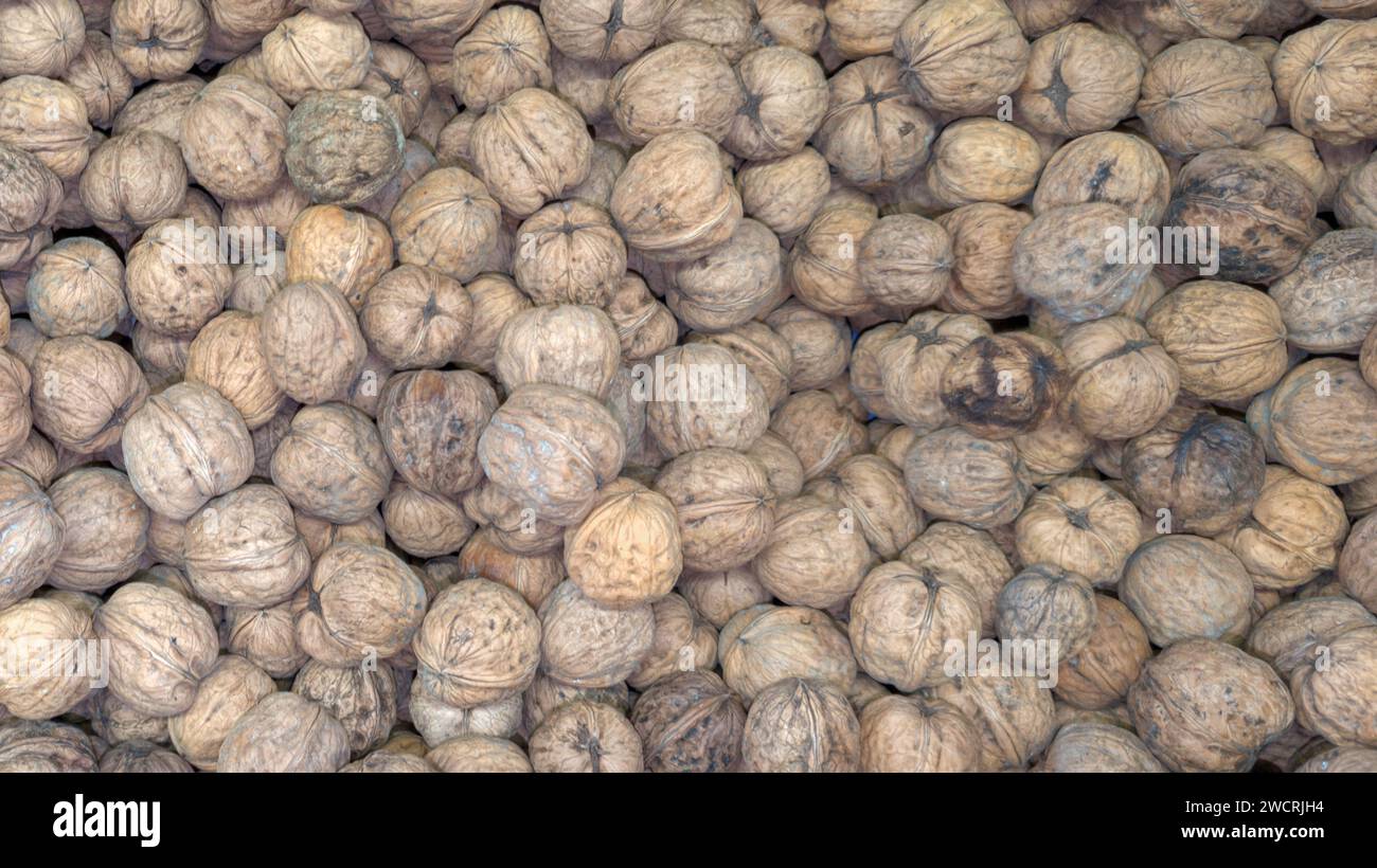 Whole nut walnuts in a pile as a background at the market in top view Stock Photo