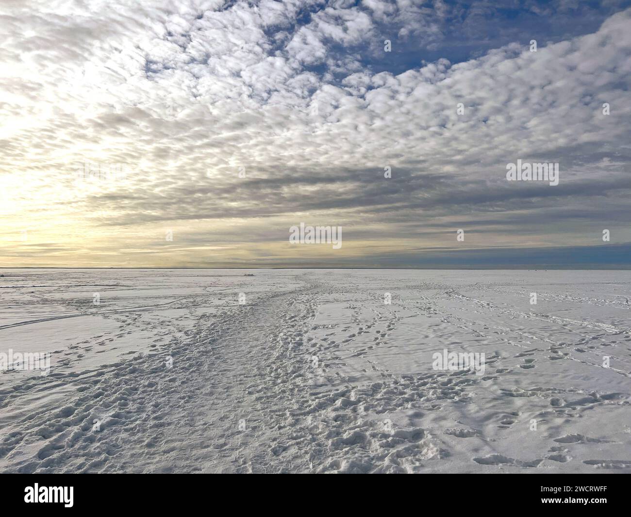 snow valley of frozen finland gulf. Beautuful spindrift clouds on blue sky Stock Photo