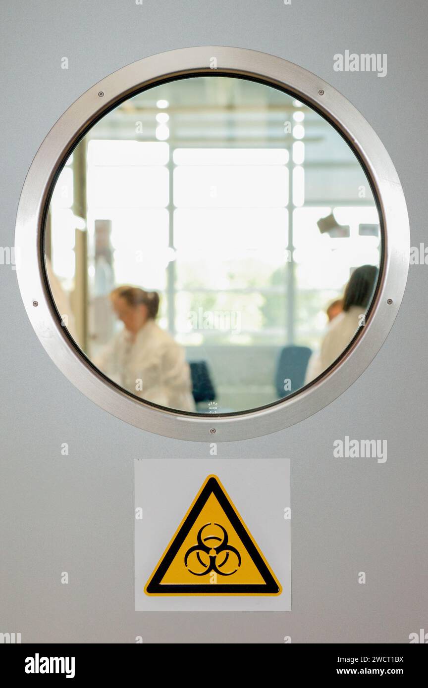Hamburg, Germany, October 1, 2013 - View through a window into a research laboratory. Below the warning symbol 'Biohazard' Stock Photo